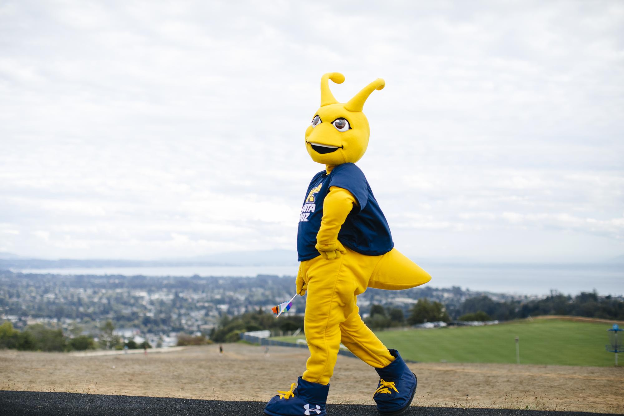 Banana Slug Mascot strikes a pose a different pose.