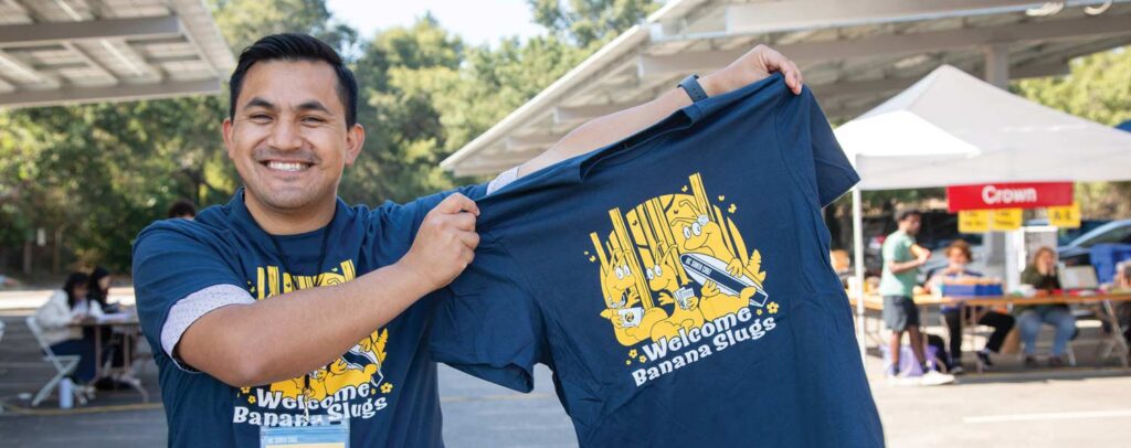 Volunteer held up the shirt at the event: Welcome Banana Slugs